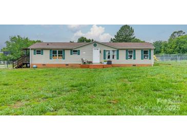 Charming single-story home featuring a well-maintained lawn, complemented by green shutters and a welcoming front porch at 110 Crescent Heights Dr, Salisbury, NC 28146