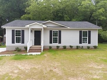Charming single-story home with gray siding, black shutters, and a welcoming front porch at 12 Watts St, York, SC 29745