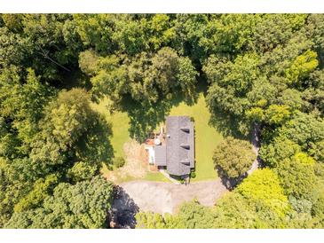Stunning aerial view of home surrounded by lush green trees and a well-maintained yard at 1738 Charlotte Hwy, Lancaster, SC 29720