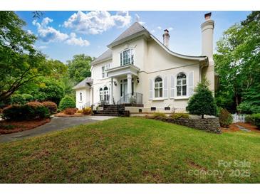 Stately two-story traditional home featuring a manicured front lawn and multiple windows with white shutters at 2972 Kaneland Ct, Rock Hill, SC 29732