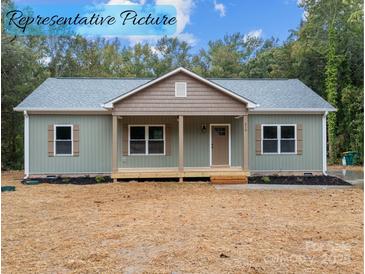 Charming exterior of home featuring a cozy front porch and well-manicured lawn at 317 N Cemetery St, Richfield, NC 28137