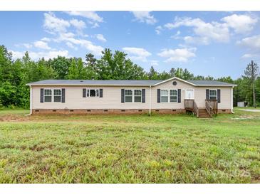 Charming single-story home featuring a well-maintained lawn and traditional architecture with black shutters at 4518 Logging Rd, Lancaster, SC 29720