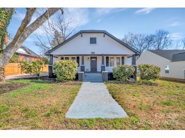 Charming home featuring a covered porch and inviting front yard landscape at 1003 S Ridge Ave, Kannapolis, NC 28083