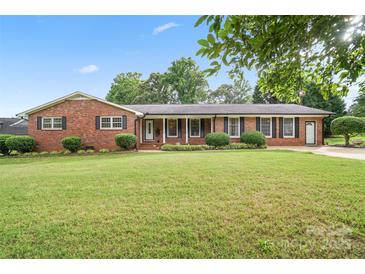 Charming brick home with well-manicured lawn, complemented by lush greenery and a welcoming entrance, perfect for curb appeal at 1155 Melrose Dr, Rock Hill, SC 29732