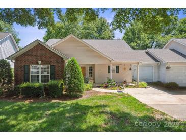 Charming single story home featuring manicured lawn and tidy landscaping in a well-maintained community at 119 Ashwood Ln, Mooresville, NC 28117