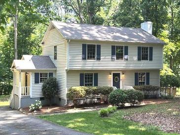 Charming two-story home featuring a landscaped yard and classic architectural details at 14027 Hackamore Dr, Matthews, NC 28105
