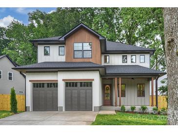 Beautiful two-story home featuring a two-car garage and a charming covered front porch at 1834 Arnold Dr, Charlotte, NC 28205