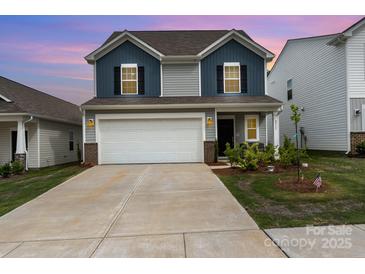 Charming two-story home featuring blue and gray siding, a two-car garage, and well-maintained landscaping at 2317 Trollinger Dr, Catawba, NC 28609