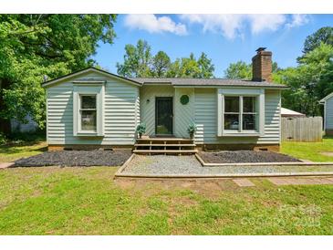 Charming single story home with a chimney, green yard and landscaped front at 6718 Pueblo Ln, Charlotte, NC 28227