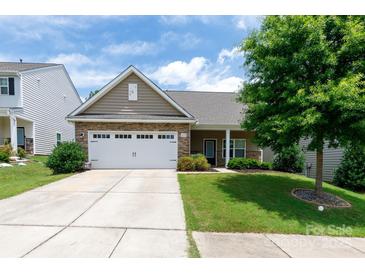 Charming single-story home boasts a stone-accented facade, attached two-car garage, and lush green lawn at 679 Cape Fear St, Fort Mill, SC 29715