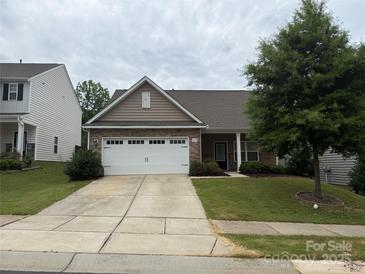 Charming single-story home featuring stone accents, a two-car garage, and a well-manicured lawn at 679 Cape Fear St, Fort Mill, SC 29715