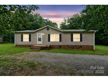 Charming single-story home with neutral siding, black shutters, and a well-manicured front lawn at 1245 Forest Ridge Rd, Bessemer City, NC 28016