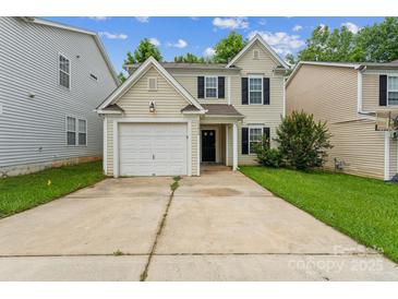 Charming two-story home featuring a white garage door, black shutters and a well-maintained front yard at 13413 Golden Apple Ct, Charlotte, NC 28215