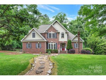 Charming brick home with a manicured lawn and stone pathway leading to a welcoming red door at 2030 Fasana Rd, York, SC 29745
