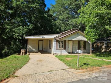 Modest single-story home with a driveway and a small front yard shaded by mature trees at 211 Putnam St, Shelby, NC 28152