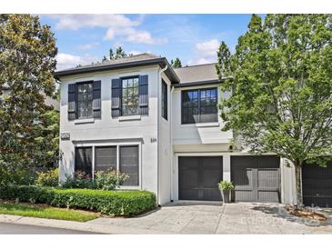 Charming two-story home with well-manicured landscaping, a two-car garage, and stylish black shutters at 224 Wendover Heights Cir, Charlotte, NC 28211