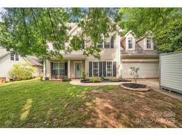 Charming two-story home with a well-manicured lawn and inviting front porch at 4502 Magnolia Ridge Dr, Waxhaw, NC 28173