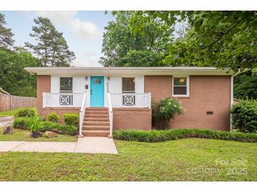 Charming brick home with a bright turquoise front door and white trim at 4533 Gainesborough Rd, Charlotte, NC 28205
