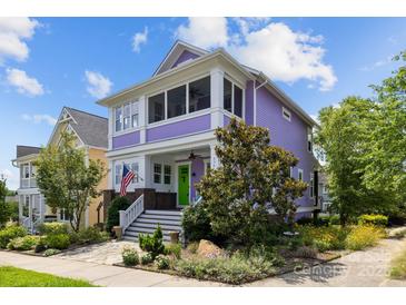 Eye-catching two-story home with a spacious porch, green door, manicured landscaping and vibrant purple facade at 536 Spring Landing Dr, Rock Hill, SC 29730