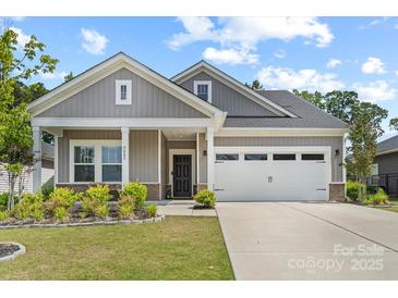 Charming single-story home featuring a well-manicured lawn, a two-car garage, and a welcoming front porch at 9009 Myrna Dr, Gastonia, NC 28056