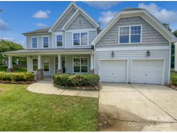 Charming two-story home featuring a manicured lawn and a two-car garage at 2479 N Legacy Park Blvd, Fort Mill, SC 29707