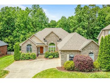 Charming brick home with manicured landscaping and a well-maintained front yard at 305 River Birch Cir, Mooresville, NC 28115