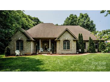 Charming brick home with lush lawn and manicured landscaping creates inviting curb appeal at 3273 16Th Ne St, Hickory, NC 28601