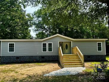 Charming single-story home with gray siding, stone accents, and a newly constructed wooden staircase at 5458 Foxcroft Dr, Fort Lawn, SC 29714