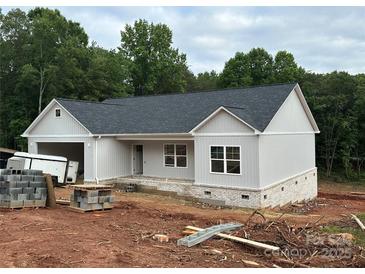 Charming single story home with light gray siding, a dark roof, and a brick foundation awaiting completion at 63 Cornerstone Dr, Taylorsville, NC 28681