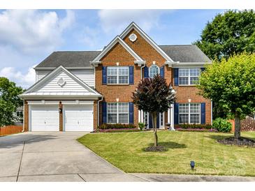 Charming two-story brick home with a well-manicured lawn and inviting curb appeal at 8608 Talbert Paige Ct, Charlotte, NC 28277