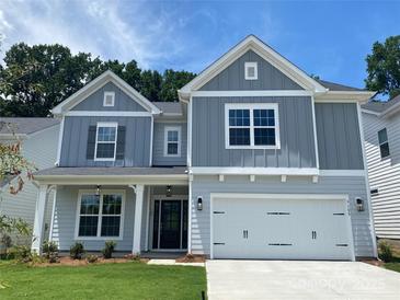 Charming two-story home with a well-manicured lawn, inviting entrance, and attached two-car garage at 9108 Dulwich Dr # Ken0074, Charlotte, NC 28215