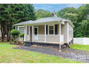 Charming single-story home featuring a cozy front porch and landscaped garden at 1036 20Th Ne St, Hickory, NC 28601