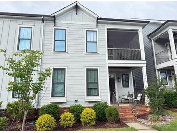 Charming two-story townhome with a screened porch and landscaped front yard at 114 Mint Ave # A, Mooresville, NC 28117