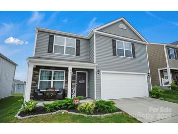 Charming two-story home with a well-maintained lawn, two-car garage, and welcoming front porch at 2013 Eastway Dr, Dallas, NC 28034