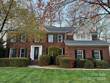 Traditional brick two-story home with manicured lawn and black shutters, offering classic curb appeal at 21621 Crown Lake Dr, Cornelius, NC 28031