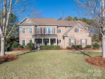 Traditional brick home with a well-manicured lawn and inviting covered front porch at 2785 Disney Pl, Indian Land, SC 29707