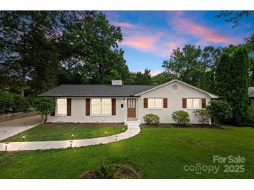 Charming, freshly renovated single-story home with manicured lawn and a welcoming walkway at 4913 Seacroft Rd, Charlotte, NC 28210