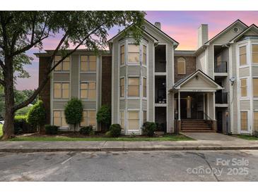 Charming condo building featuring beautiful architecture, landscaping and staircase at 6203 Rosecroft Dr, Charlotte, NC 28215