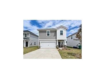 Charming two-story home featuring a front-facing garage, manicured lawn, and inviting entrance at 804 Blue Canyon Dr, York, SC 29745
