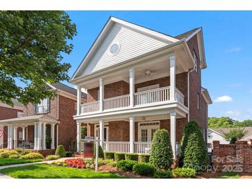 Charming brick home featuring a double front porch, manicured landscaping, and a welcoming facade at 108 Forrester Ave, Belmont, NC 28012