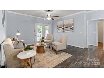 Bright living room featuring hardwood floors, ceiling fan, and neutral color scheme at 11911 Ridgeway Park Dr, Charlotte, NC 28277