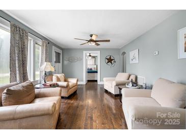 Inviting living room featuring hardwood floors, ceiling fan, and neutral-toned furniture at 1266 18Th Ne St, Hickory, NC 28601