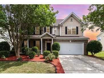 Charming two-story home with a brick facade, manicured landscaping, and a two-car garage at 13305 Mallard Landing Rd, Charlotte, NC 28278