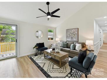 Bright living room with stylish decor, a patterned rug, and an open and airy layout at 2017 Brewton Dr, Charlotte, NC 28206