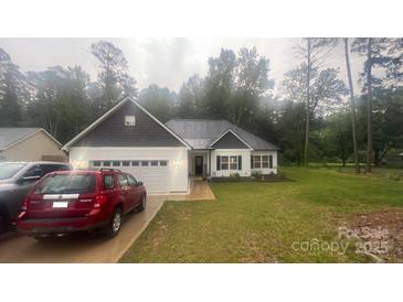 Charming single-story home with a white exterior, a dark shingled roof and an attached two-car garage at 2705 Enon Church Rd, Salisbury, NC 28147