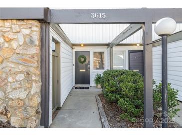 Inviting front entrance featuring stone accents, neutral siding, and well-maintained landscaping at 3615 Maple Glenn Ln, Charlotte, NC 28226