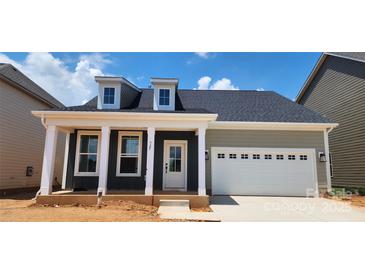 Charming single-story home featuring a covered front porch and an attached garage at 725 Sirius Ln # 90, York, SC 29745