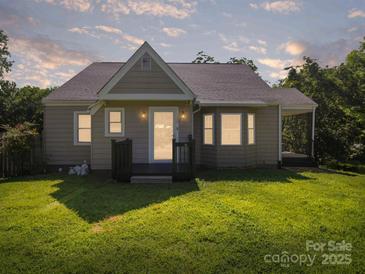Charming single story home featuring a well-manicured lawn and inviting front porch at 322 Peachtree St, Albemarle, NC 28001