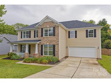 Charming two-story home with a brick and siding facade, manicured lawn and attached two-car garage at 4001 Brook Valley Run, Monroe, NC 28110