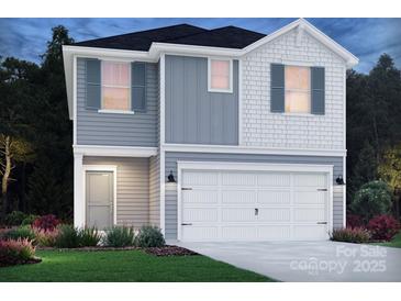 Charming two-story home featuring a two-car garage, complemented by tasteful landscaping at 406 Luna Ln, Shelby, NC 28152